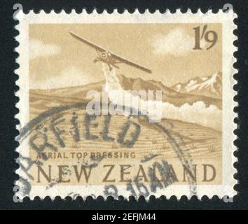 NEW ZEALAND - CIRCA 1963: stamp printed by New Zealand, shows Plane spraying farmland, circa 1963 Stock Photo