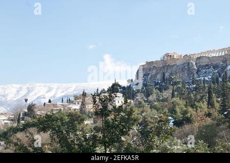 Athens, Greece - February 17 2021: Acropolis view in winter, with snow in the mountains