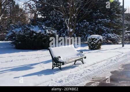 Bench at City Park under Snow Stock Photo