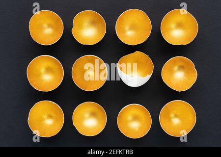 Splurge concept. Golden eggshell isolated on black background. Glamorous eggs. Creative Easter design template for advertising banners, invitations. T Stock Photo
