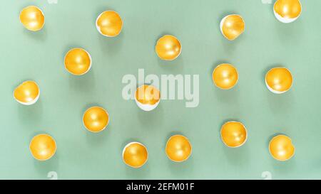 Abstract modern Easter background with eggshell in gold color on gray-green background. Contemporary art concept dedicated to Easter. Gold eggshell pa Stock Photo