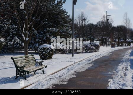 Bench at City Park under Snow Stock Photo