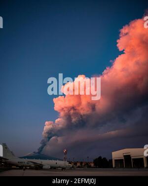 Sigonella, Italy. 16th Feb, 2021. Europes most active volcano Mt. Etna, spews a cloud of ash see from the flight line at U.S. Naval Base Sigonella February 16, 2021 in Sigonella, Sicily, Italy. Etna is the highest and most active volcano in Europe. Credit: Planetpix/Alamy Live News Stock Photo