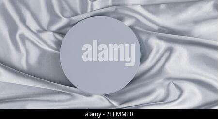 Geometric platform podium on light gray silk satin background. Blank minimal cylinder form mock up background for cosmetic product presentation Stock Photo