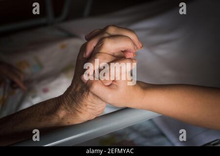 granddaughter holding the hand Stock Photo
