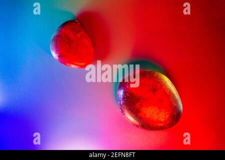Two tumbled mineral gems colorfully illuminated showing abstract details. Stock Photo