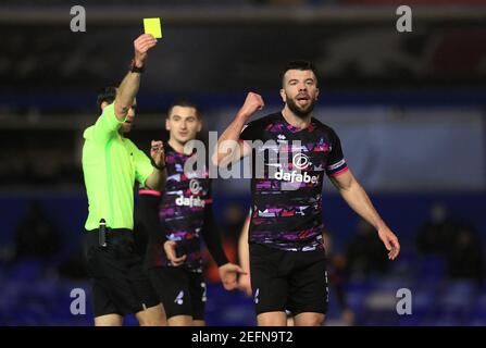Norwich City's Grant Hanley (right) receives a yellow card during the Sky Bet Championship match at St Andrew's Trillion Trophy Stadium, Birmingham. Picture date: Wednesday February 17, 2021. Stock Photo