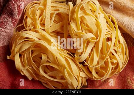 Dried egg noodles, called fettuccine in Italian Stock Photo