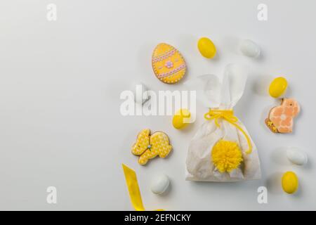Easter concept - bunny shaped bag with eggs and flowers on bright yellow background, Stock Photo