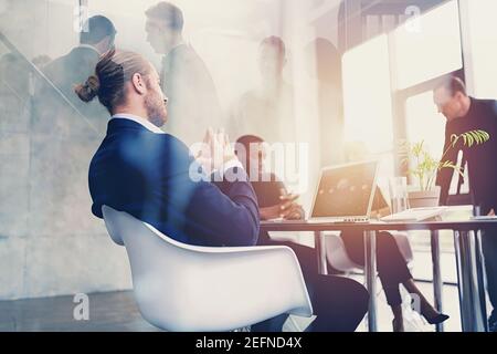 Hipster business man in elegant suit is on business meeting in the office. Double exposure effects Stock Photo
