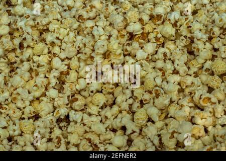 Popcorn from maize or popped corn, popcorns, or pop-corn is a variety of corn kernel which expands and puffs up when heated Stock Photo