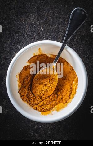 Indian turmeric powder. Turmeric spice. Ground turmeric in bowl. Top view. Stock Photo