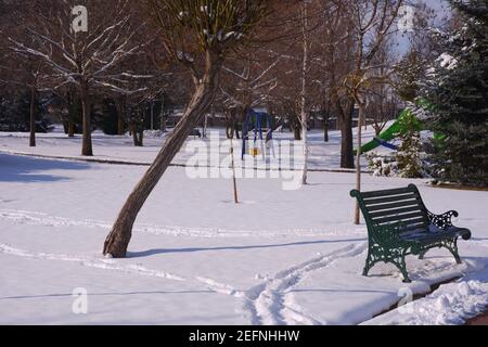 Bench at City Park under Snow Stock Photo