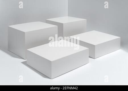 Four white cubes boxes on white background Stock Photo