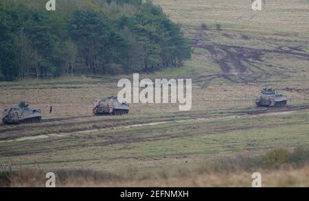 British Army Warrior light infantry fighting vehicle battle tank FV 510 with two Mechanized Repair Vehicle FV 512 in a demonstration of firepower, Sal Stock Photo