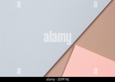 Abstract geometric shapes and lines in light blue, pastel pink colors on light brown paper background