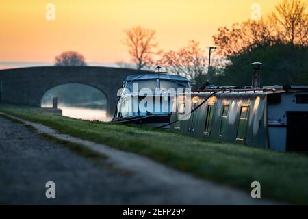 Canal boat early morning sunrise with golden light in sky on the River Trent narrowboat in nottingham Nottinghamshire Stock Photo