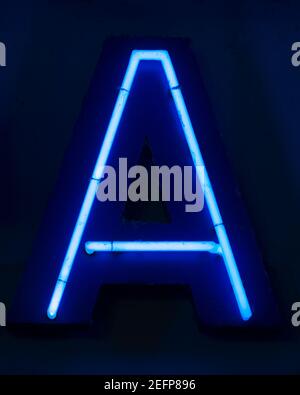 Blue shining neon letter A at night Stock Photo