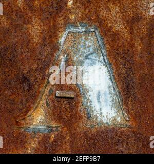 Remains of the letter A on rusty metal plate Stock Photo