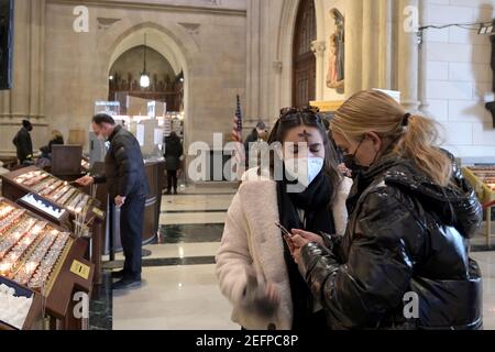 New York, USA. 17th Feb, 2021. Church goers wear ash on their foreheads inside St. Patrick's Cathedral on Ash Wednesday in New York, NY, February 17, 2021. (Photo by Anthony Behar/Sipa USA) Credit: Sipa USA/Alamy Live News Stock Photo