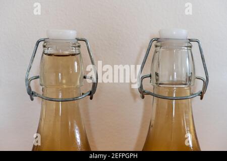 Close up of two of flip top bottles of home made cider Stock Photo