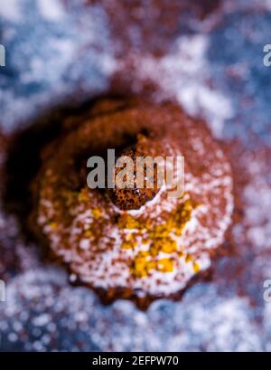 chocolate muffins sprinkled with goodies with cherries and chocolate and cocoa Stock Photo