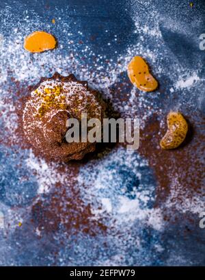 chocolate muffins sprinkled with goodies with cherries and chocolate and cocoa Stock Photo