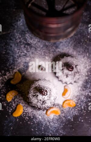 chocolate muffins sprinkled with goodies with cherries and chocolate and cocoa Stock Photo