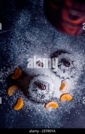 chocolate muffins sprinkled with goodies with cherries and chocolate and cocoa Stock Photo