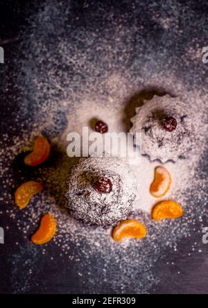 chocolate muffins sprinkled with goodies with cherries and chocolate and cocoa Stock Photo