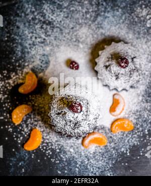 chocolate muffins sprinkled with goodies with cherries and chocolate and cocoa Stock Photo