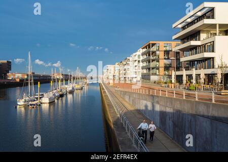 Couple with bicycle Uebrseestadt , Hanseatic City of Bremen , Germany Stock Photo