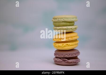 Three macarons stacked up in front of a cloud background Stock Photo