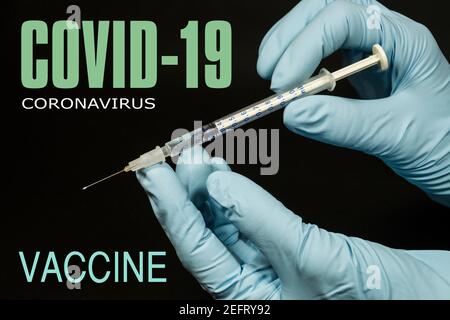 Fighting the SARS CoV-2 coronavirus pandemic.  Covid-19 (coronavirus). Syringe with a vaccine. Stock Photo