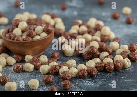 A wooden bowl full of white and brown sweet corn balls Stock Photo
