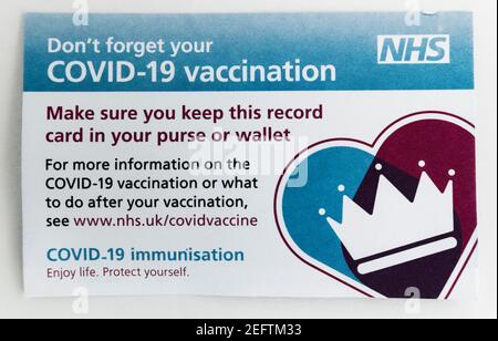 NHS Covid-19 vaccination card issued on the first vaccination during the 2020/21 pandemic Stock Photo