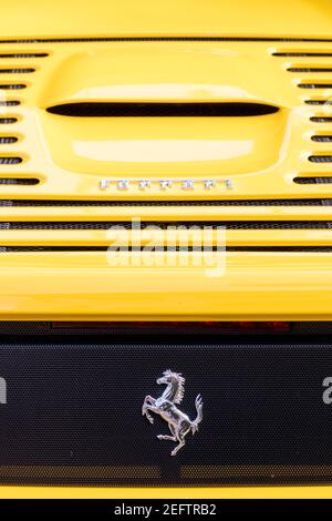 Prancing Horse and Ferrari Logo on back of yellow Ferrari 458 on display at 'Cars on Fifth' - Naples, Florida, USA Stock Photo