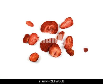Group of home cooked dehydrated dry strawberries isolated on white background top view. Dried homemade sliced organic strawberry berries close up Stock Photo