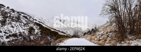 Snowy Hiking Trail views towards Lake Mountains Peak via Israel Canyon road towards Radio Towers in winter, Utah Lake, Wasatch Front Rocky Mountains, Stock Photo