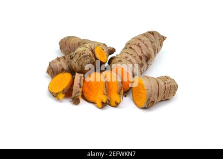 Fresh turmeric roots isolated on white background. Sliced fresh turmeric. Stock Photo