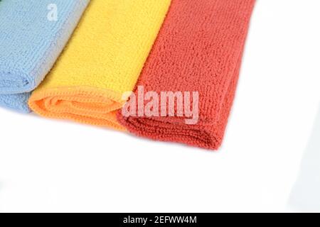 Stack of color microfiber cloths isolated on white. Row of Colorful microfiber towels. Stock Photo