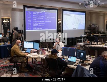 Austin, Texas Feb 17, 2021: Emergency officials monitor the Texas weather in the State Operations Center, part of the Texas Division of Emergency Management, while Texas deals with record snow and bitter cold in all 254 counties. About a quarter of the state is still without power as officials deploy state resources on a multitude of fronts. Credit: Bob Daemmrich/Alamy Live News Stock Photo
