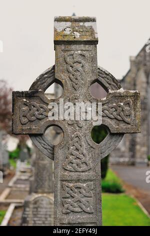 Emly, County Tipperary, Ireland. A high Celtic cross in a cemetery and churchyard at St. Aibe's Church. Stock Photo