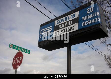 The COVID-19 Rapid Testing sign is seen outside the GS Labs Covid-19 Testing location in Lake Oswego, Ore., on 2/7/2021, amid the coronavirus pandemic. Stock Photo