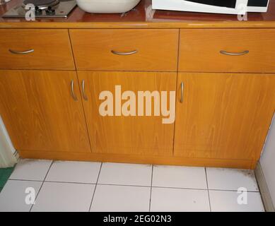 High angle view of built-in kitchen cabinet made from teak plywood, with laminated plastic countertop Stock Photo
