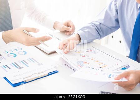 Two businessmen discussing documents at meeting table Stock Photo