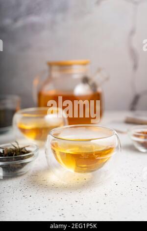 light tea flatley. pour black tea into thermos cups, on a light background. tea ceremony with different types of leaf tea Stock Photo