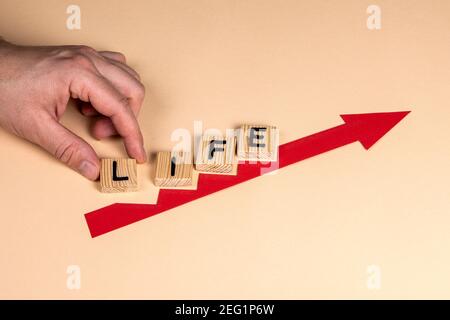 Life concept. Red arrow indicates the development and growth. Steps. Stock Photo