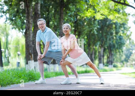Old couple sports in the park smiling Stock Photo