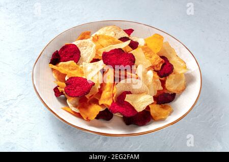 Healthy vegetable chips in a plate, healthy vegan snack Stock Photo